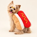 Small dog wearing hot dog bun costume with mustard